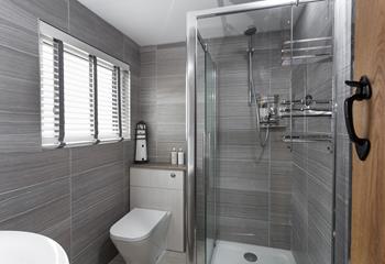 The sleek and modern bathroom is perfect for washing off the sand after a day on the beach.