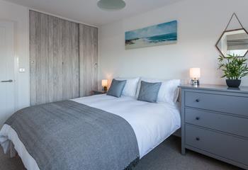 Tones of grey and fresh whites create a calming environment in bedroom 1. 