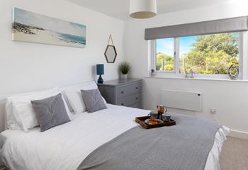 Tones of grey and fresh whites create a calming environment in bedroom 1.
