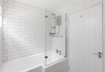 Relax and unwind in the large, modern, P-shaped bath. 
