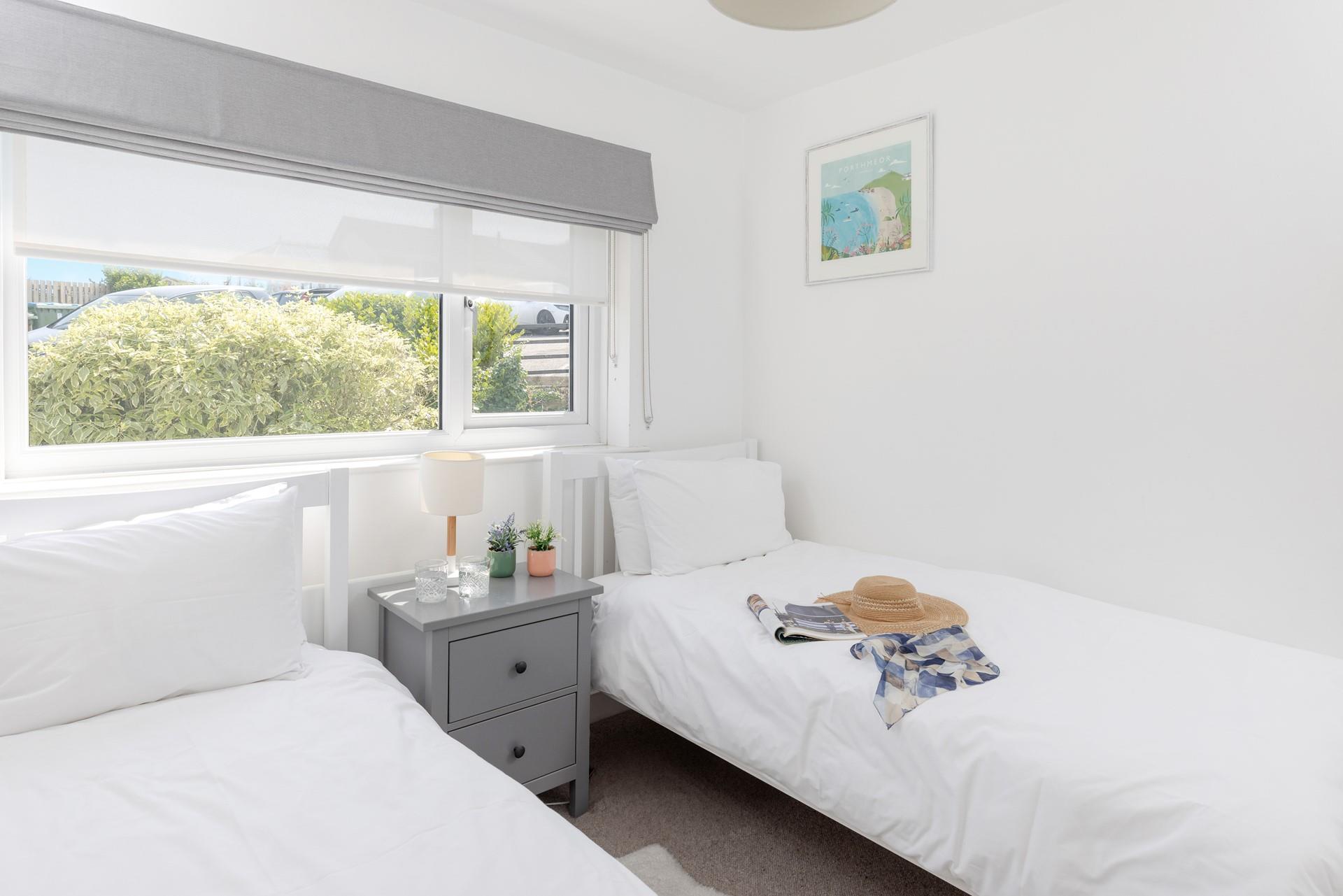 We love the fresh look of this bedroom with the Cornish artwork.