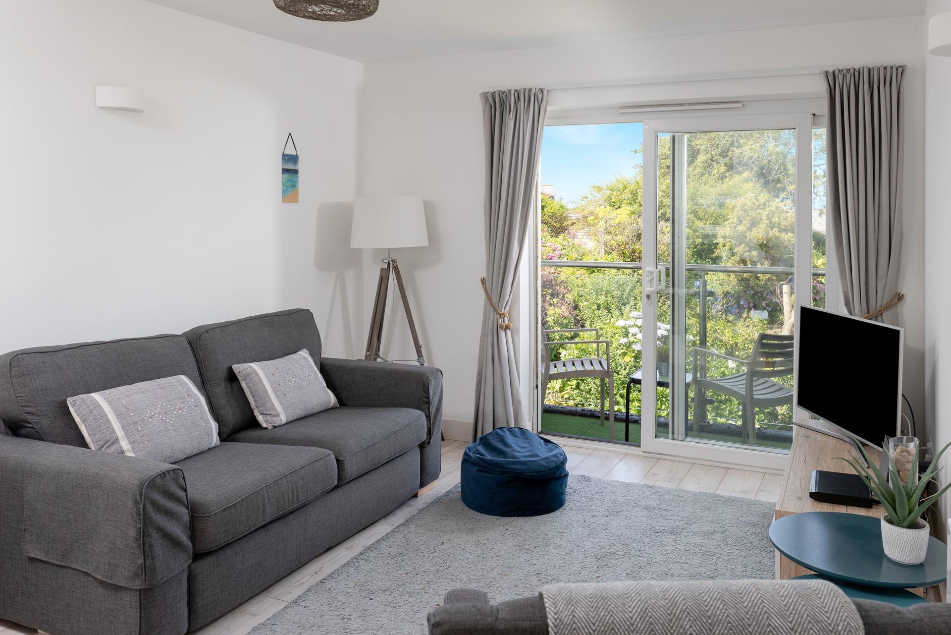 Light and spacious, the lounge benefits from plenty of natural light from the patio doors. 