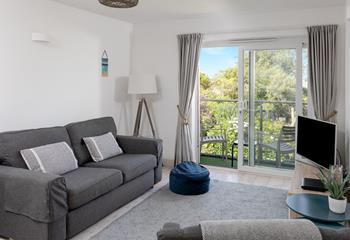 Light and spacious, the lounge benefits from plenty of natural light from the patio doors. 