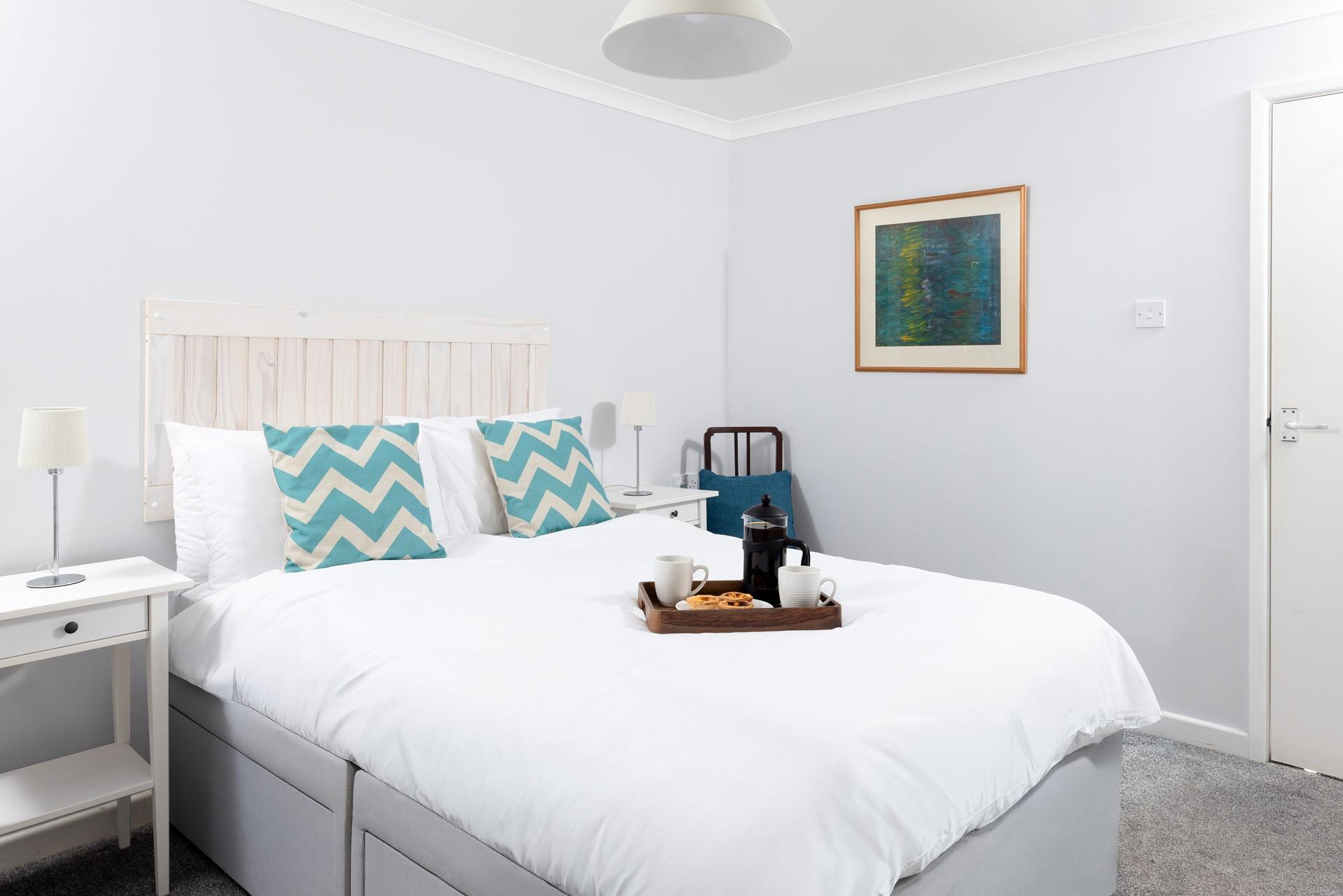 A comfortable double bed awaits in bedroom 2.