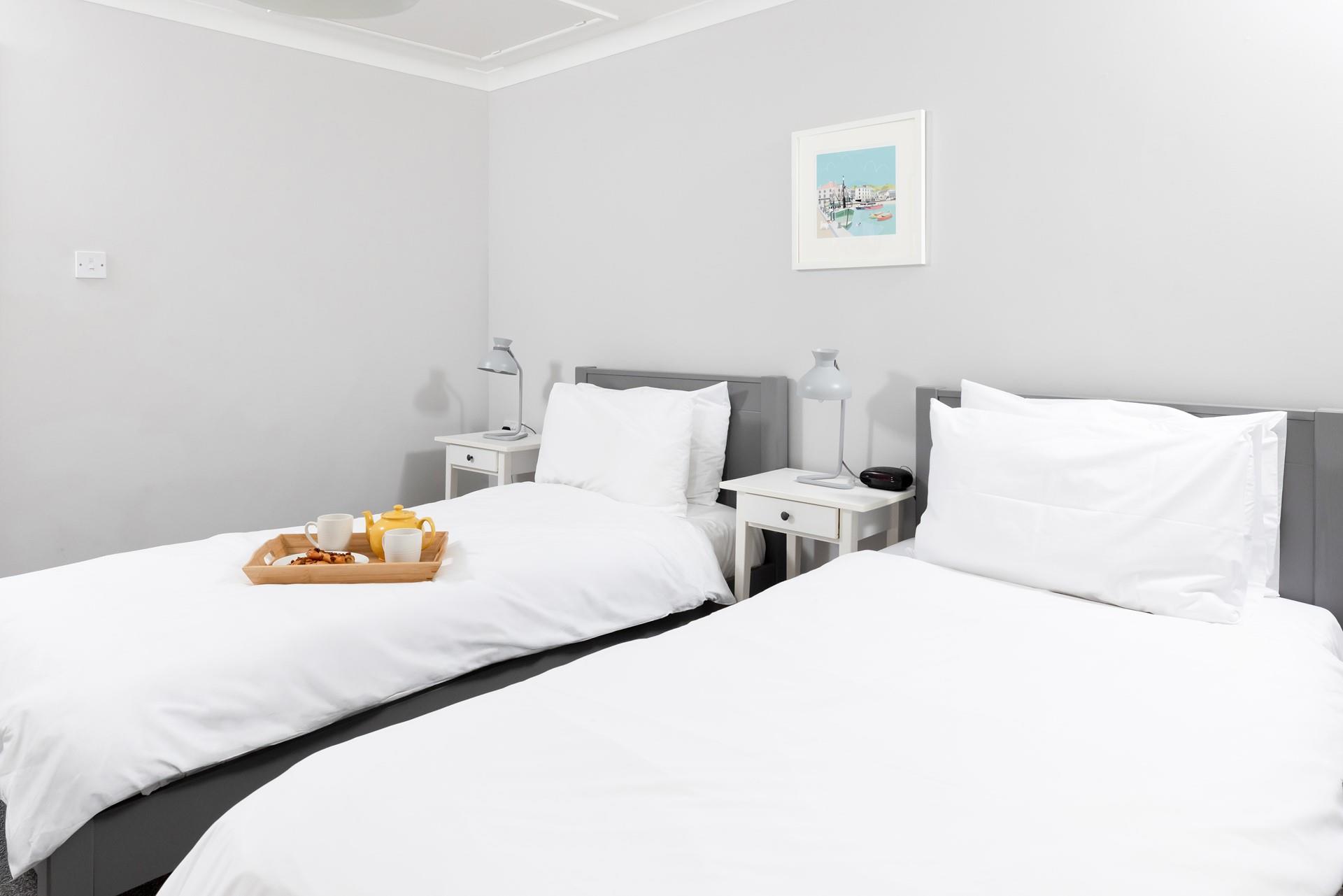 Bedroom 3 is home to twin beds, suitable for adults and children alike.