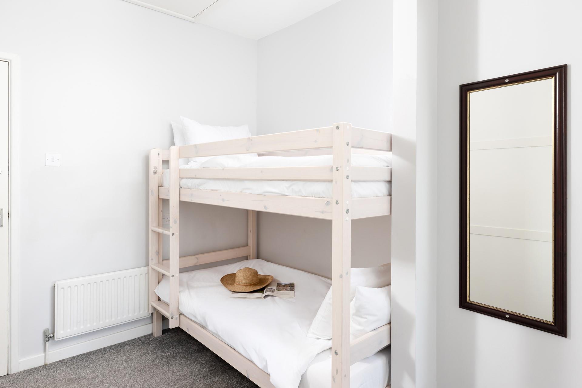 Bedroom 5 has bunk beds, ideal for young adults and children.