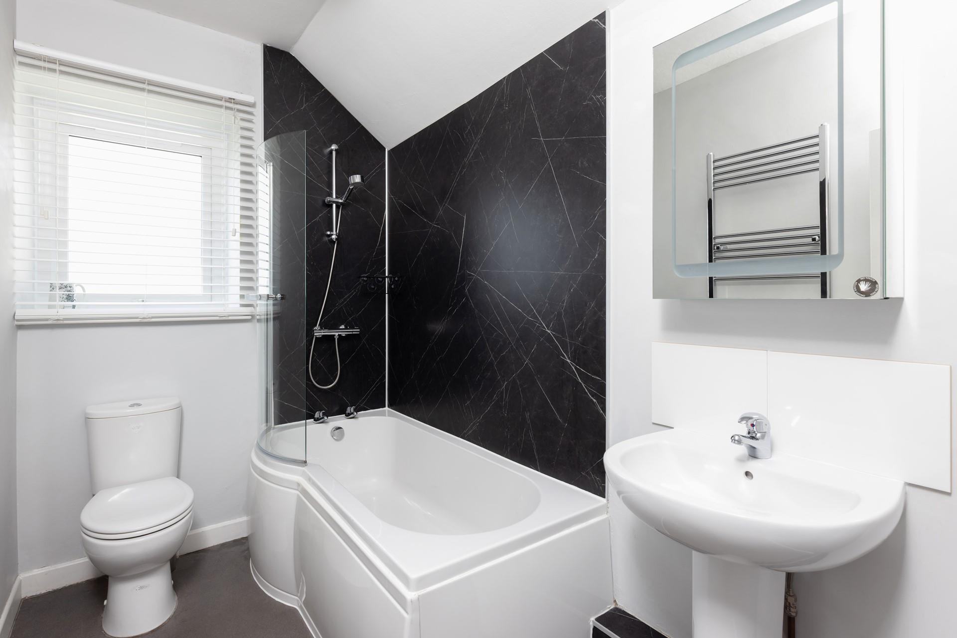 The family bathroom has a shower over bath.