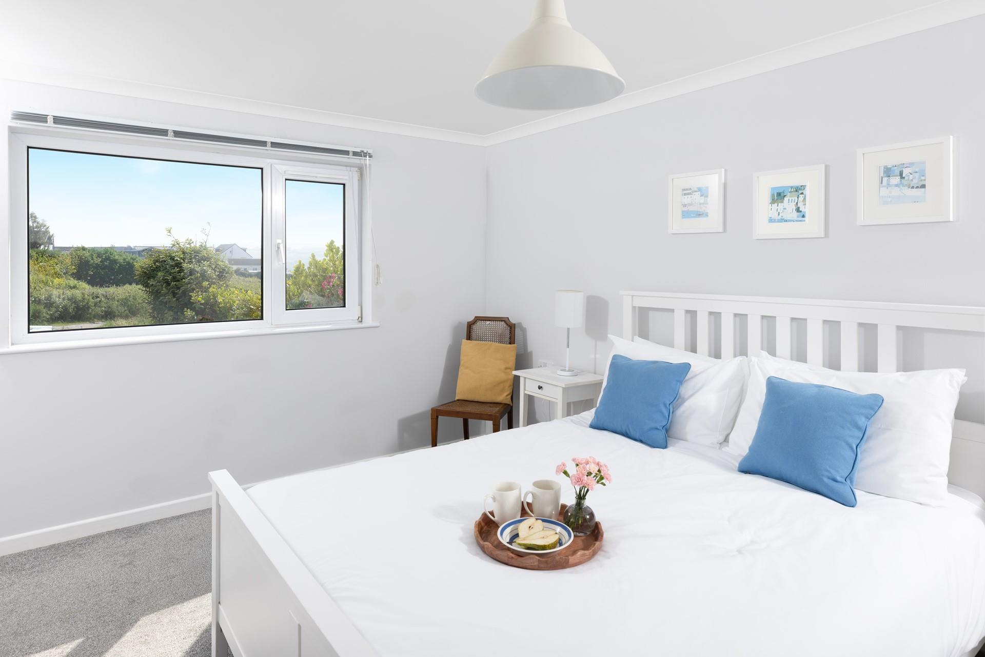 Bedroom 1 has a king size bed and views of the lush garden.