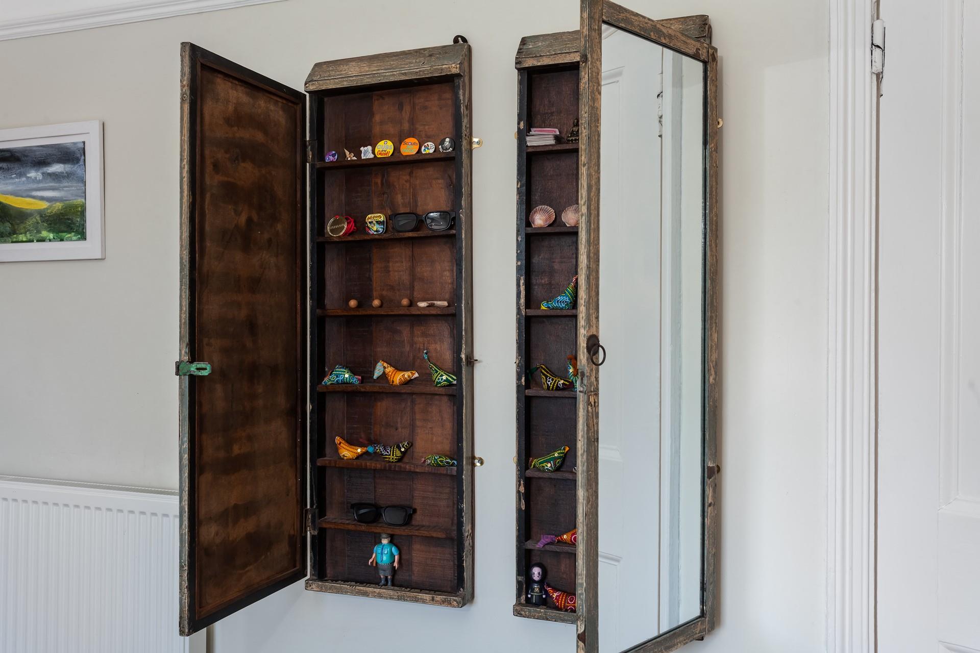 Mirror cabinets open up to showcase a charming array of ornaments! 