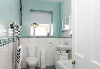 The bathroom is a fresh, bright space, perfect for an invigorating shower after a morning stroll along the beach!