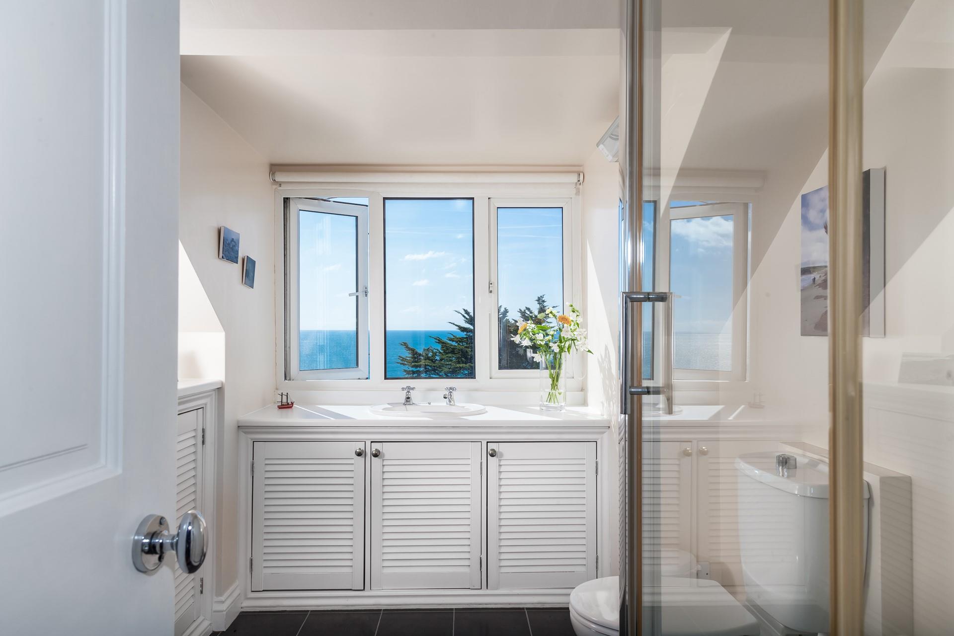 A second bathroom with glorious sea views gives everyone space and privacy to get ready.