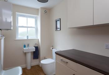 The cloakroom has a WC, basin and washing machine.