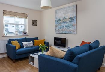 The sofas create a social space for the family to relax in the evening.