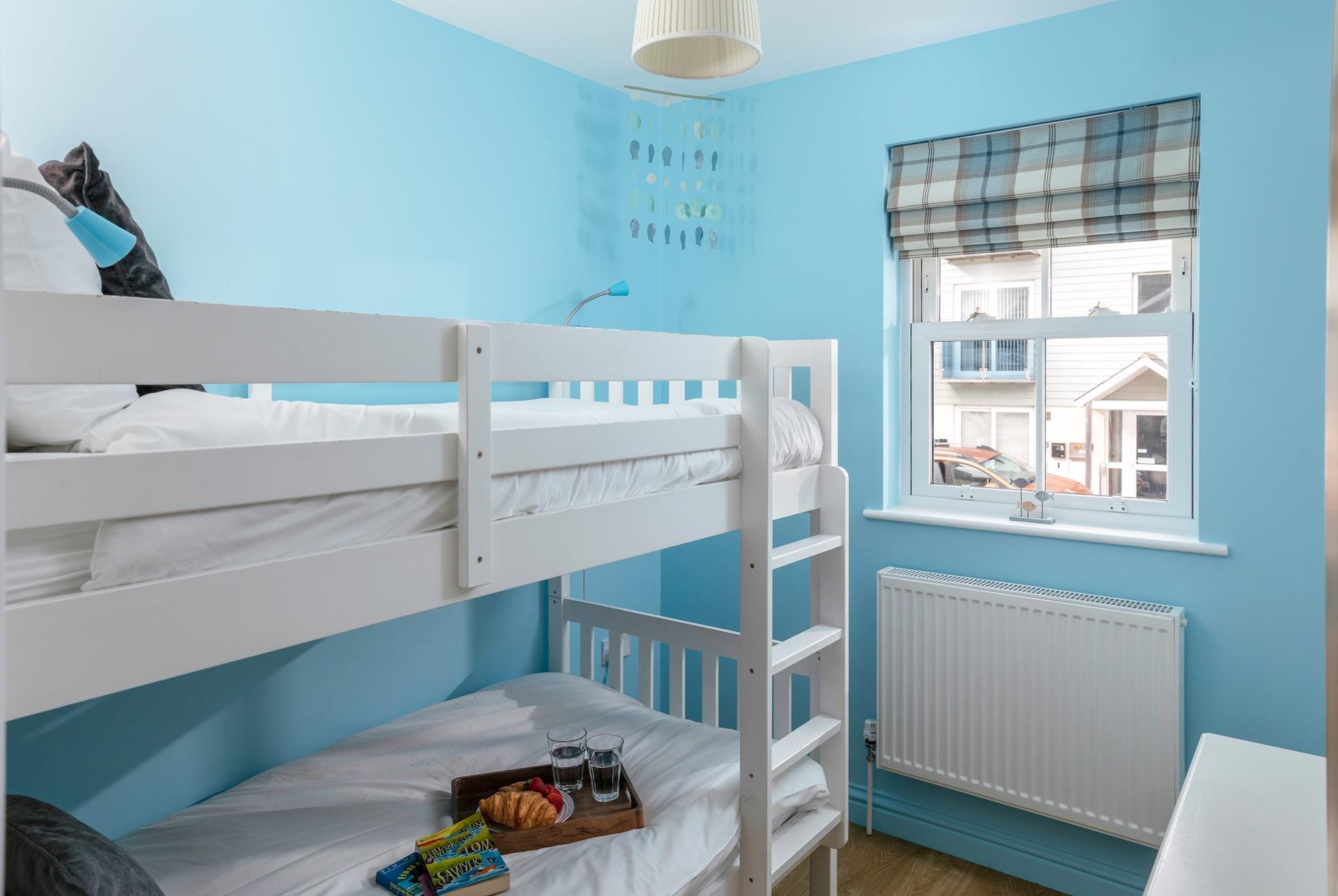Kids will love their holiday sleepovers in the bright bunk bedroom.