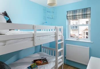 Kids will love their holiday sleepovers in the bright bunk bedroom.