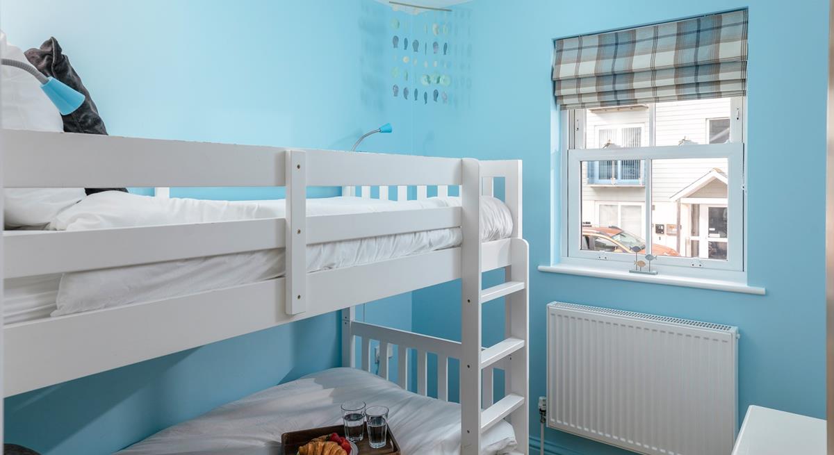 Kids will love their holiday sleepovers in the bright bunk bedroom.