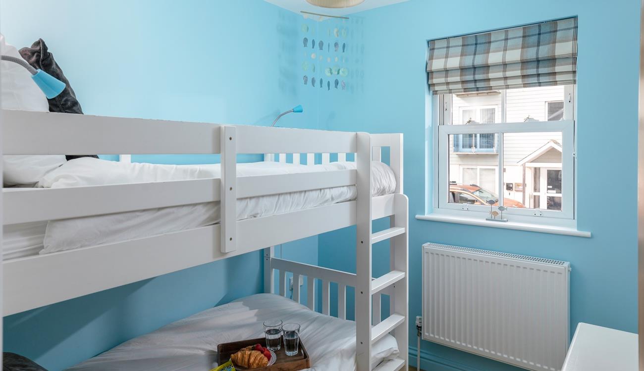 Kids will love their holiday sleepovers in the bright bunk bedroom.