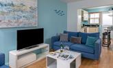 Coastal-inspired artwork adorns the living area wall. - Thumbnail Image