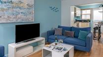 Coastal-inspired artwork adorns the living area wall.