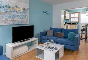 Coastal-inspired artwork adorns the living area wall.