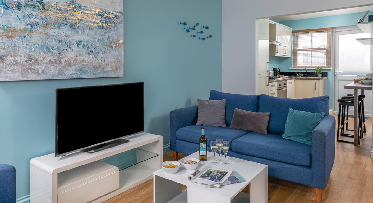 Coastal-inspired artwork adorns the living area wall.