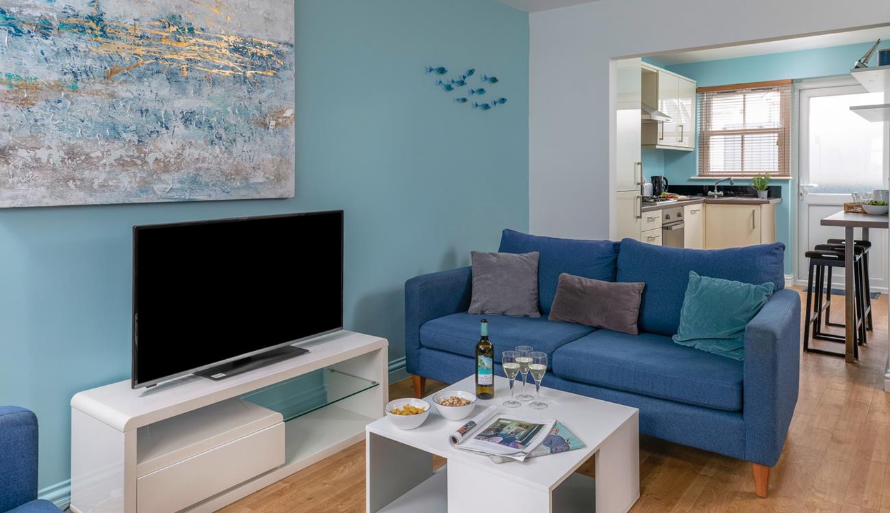 Coastal-inspired artwork adorns the living area wall.