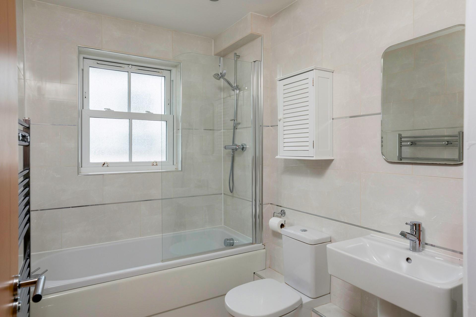 The family bathroom is spacious with a bath and shower.