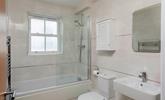 The family bathroom is spacious with a bath and shower. - Thumbnail Image