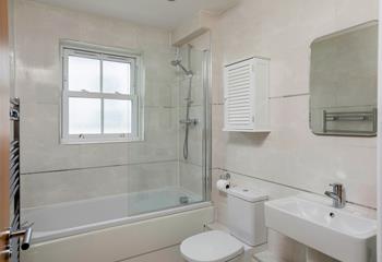 The family bathroom is spacious with a bath and shower.