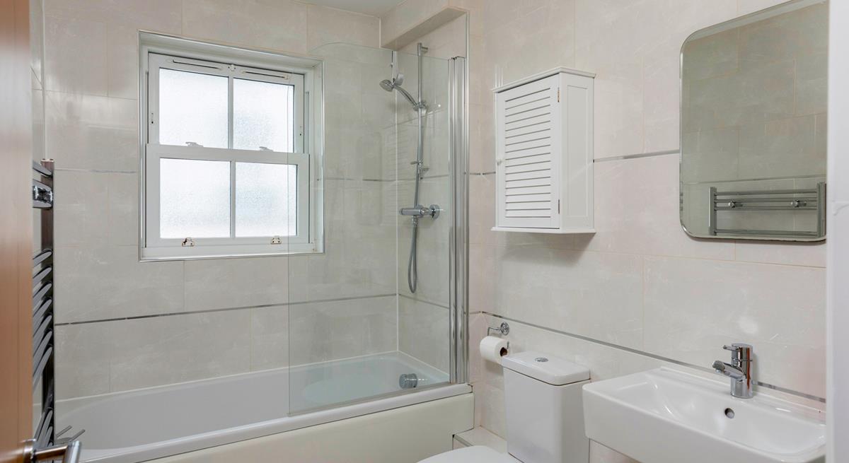 The family bathroom is spacious with a bath and shower.