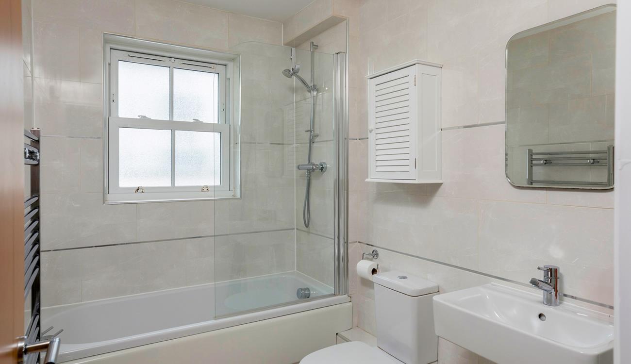 The family bathroom is spacious with a bath and shower.