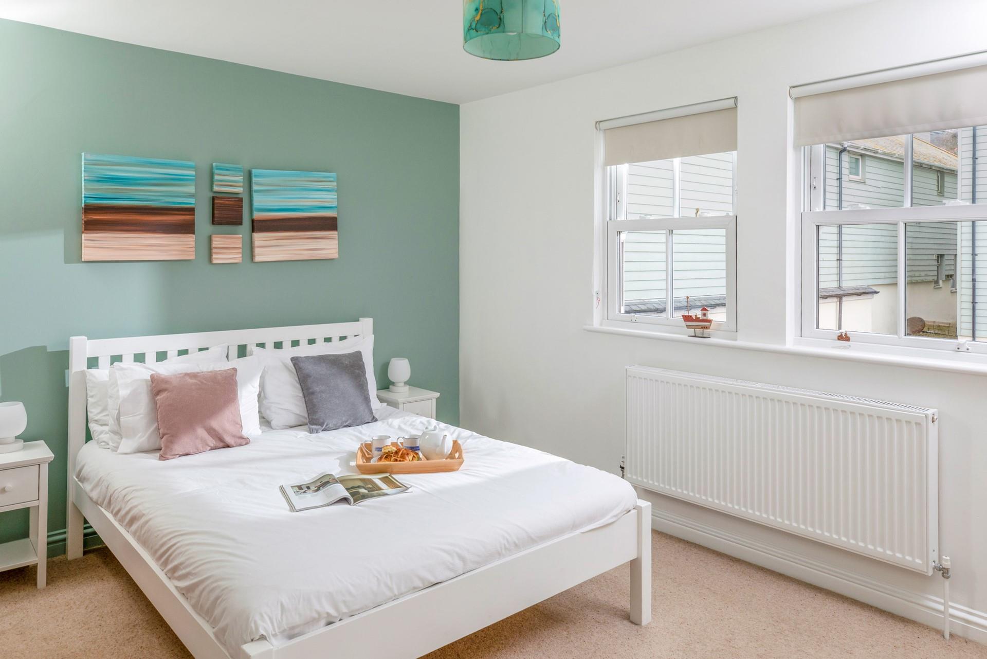 There's a serene coastal feel to the double bedroom.