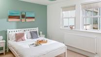 There's a serene coastal feel to the double bedroom.