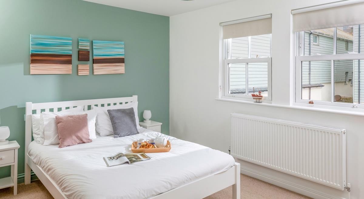 There's a serene coastal feel to the double bedroom.