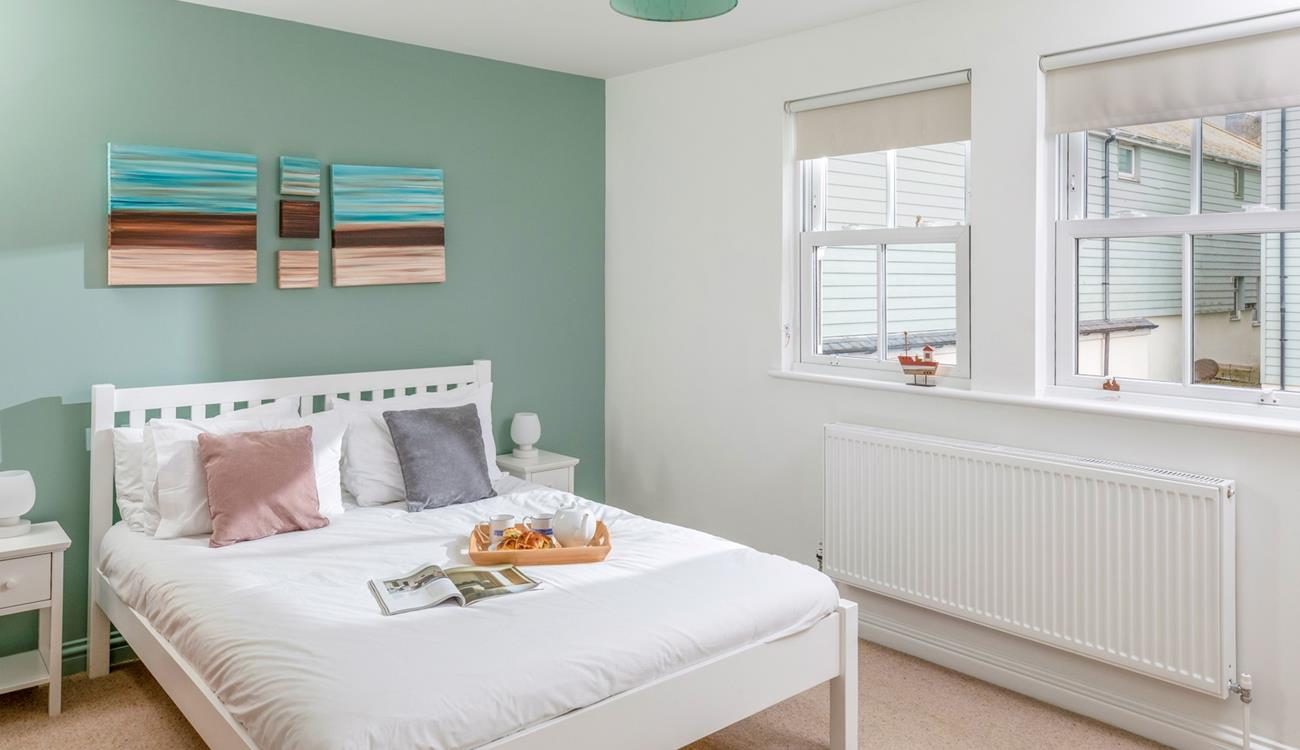 There's a serene coastal feel to the double bedroom.