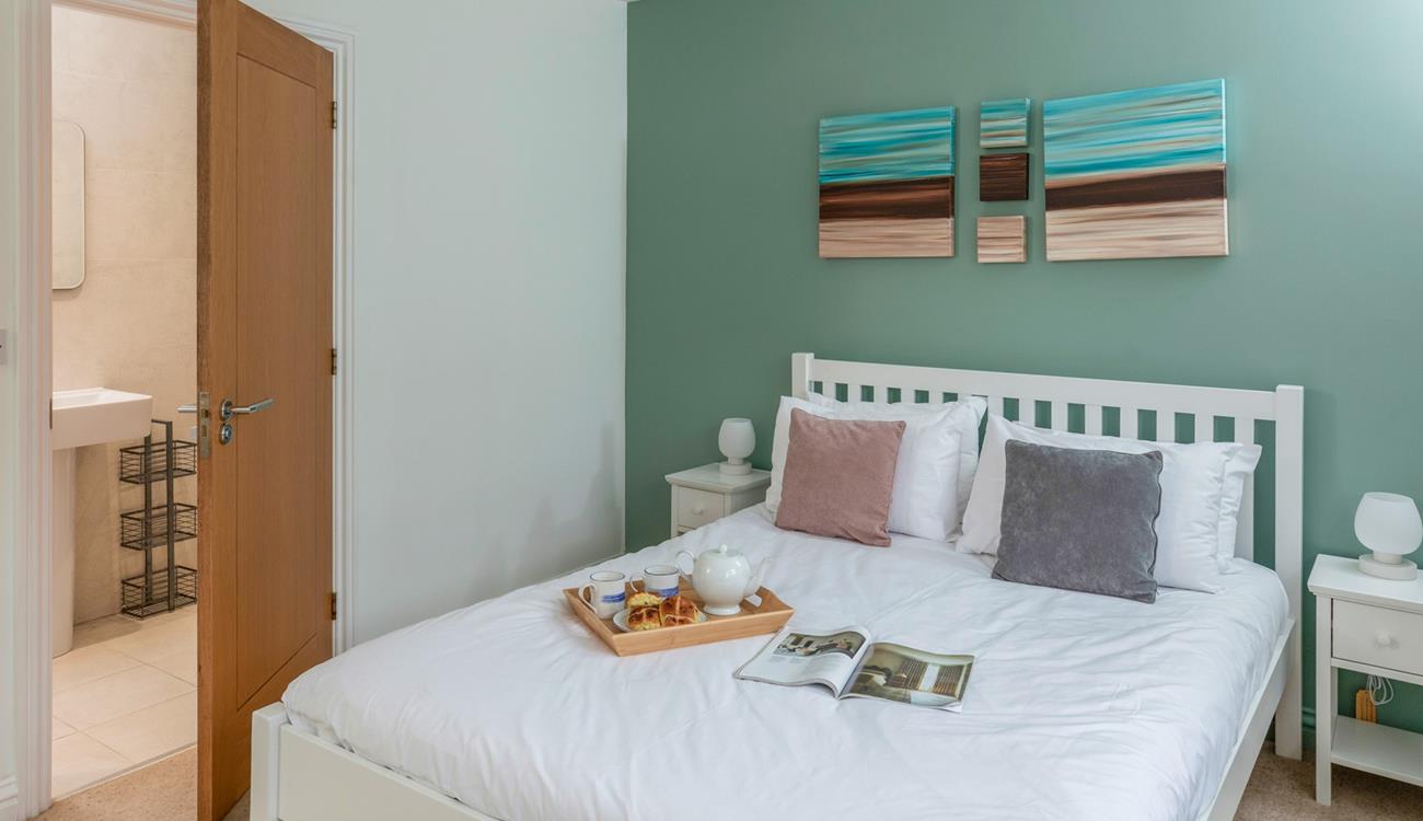 The double bedroom has a comfortable bed and en suite shower.