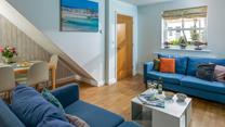 The sofas create a social space for the family to relax in the evening.