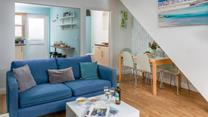 The light and airy living area is ideal for relaxing evenings together.