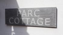 The traditional slate sign welcomes you to the property.