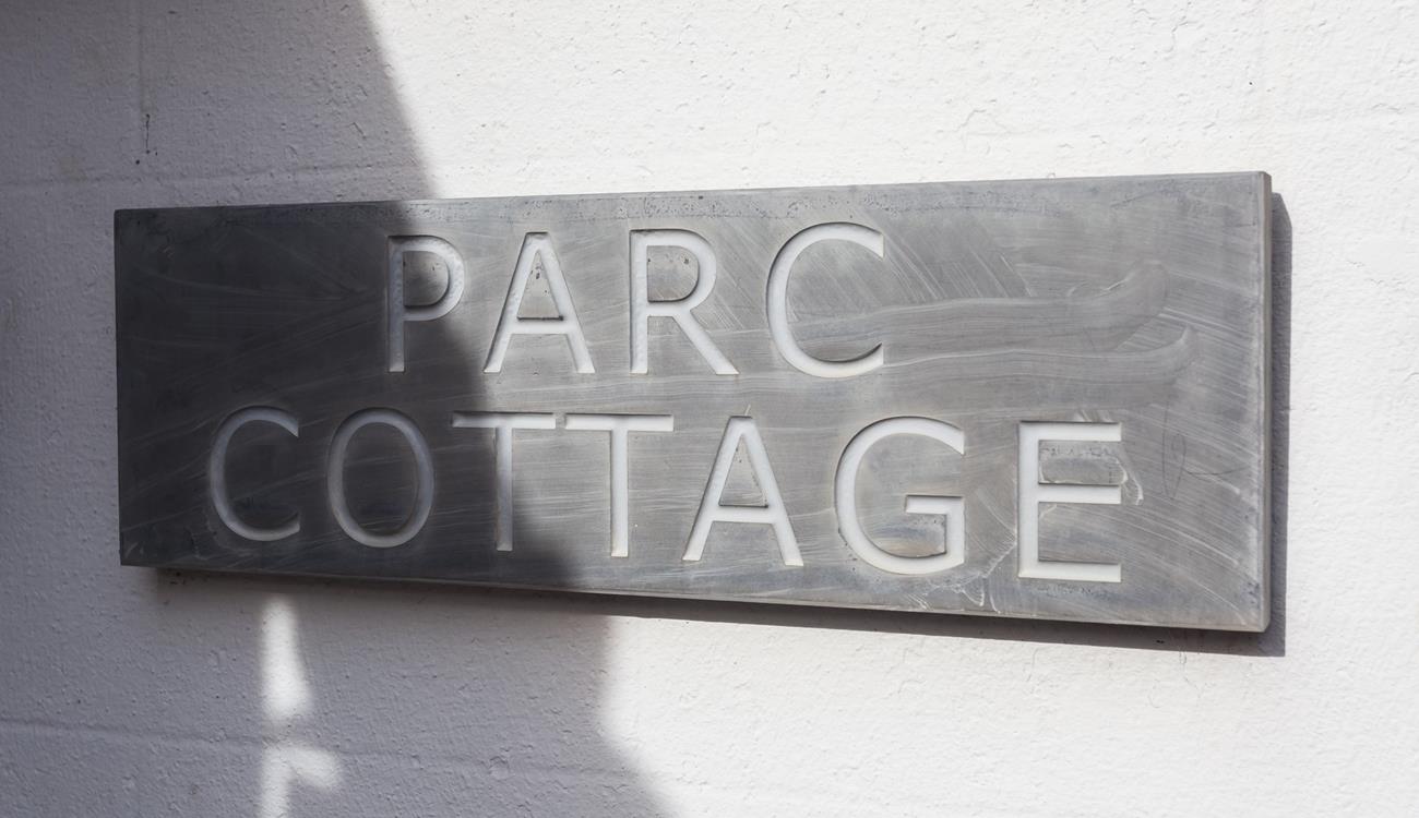 The traditional slate sign welcomes you to the property.