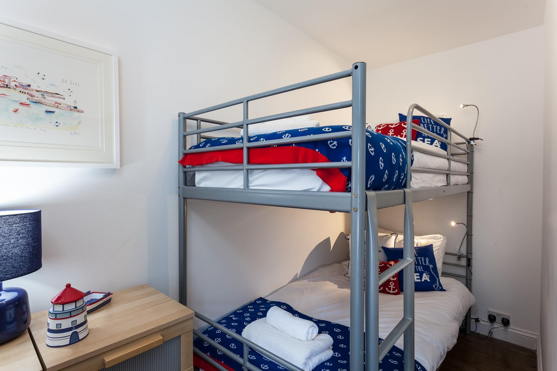 The nautical-themed bunk bedroom will be a hit with the little ones!