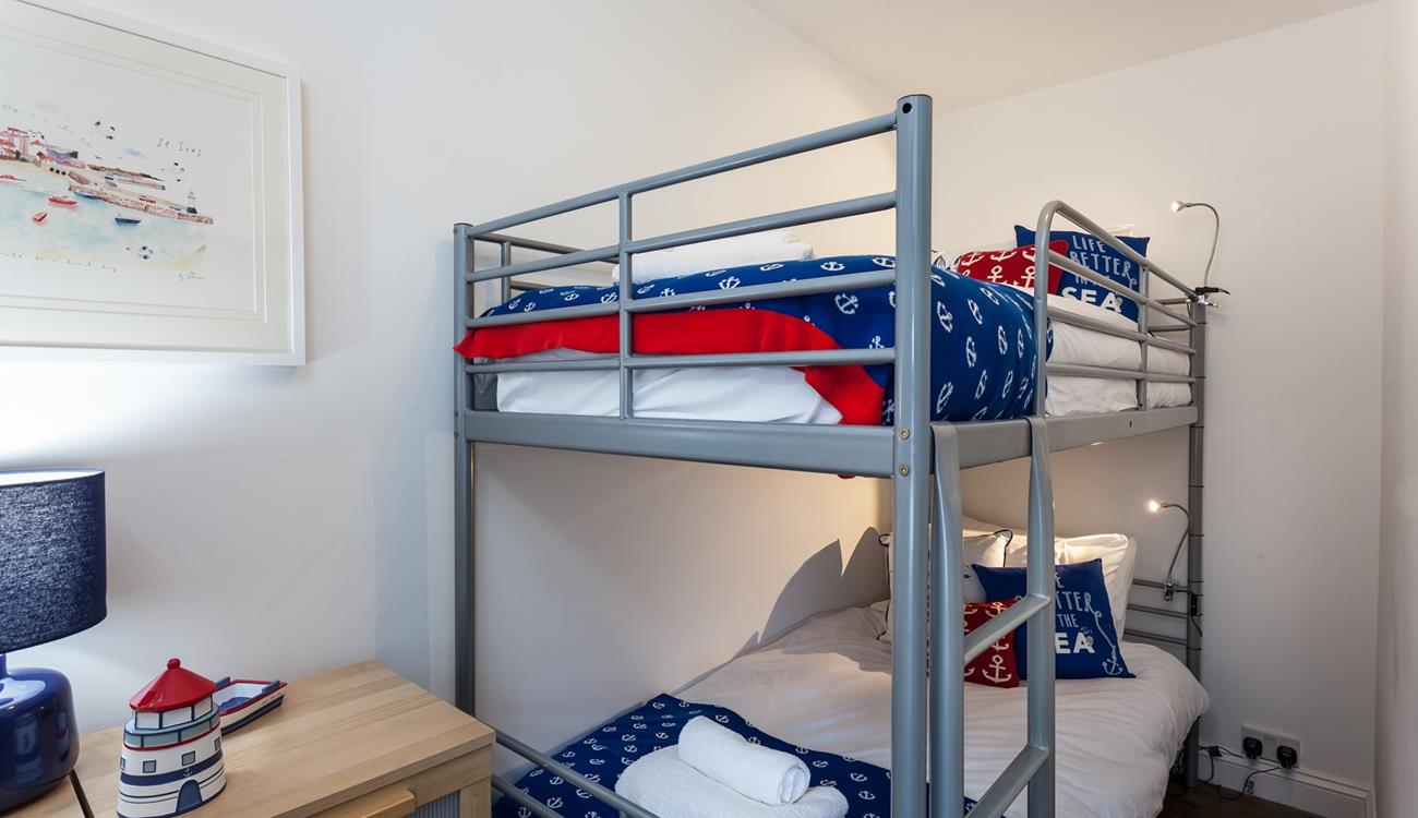 The nautical-themed bunk bedroom will be a hit with the little ones!