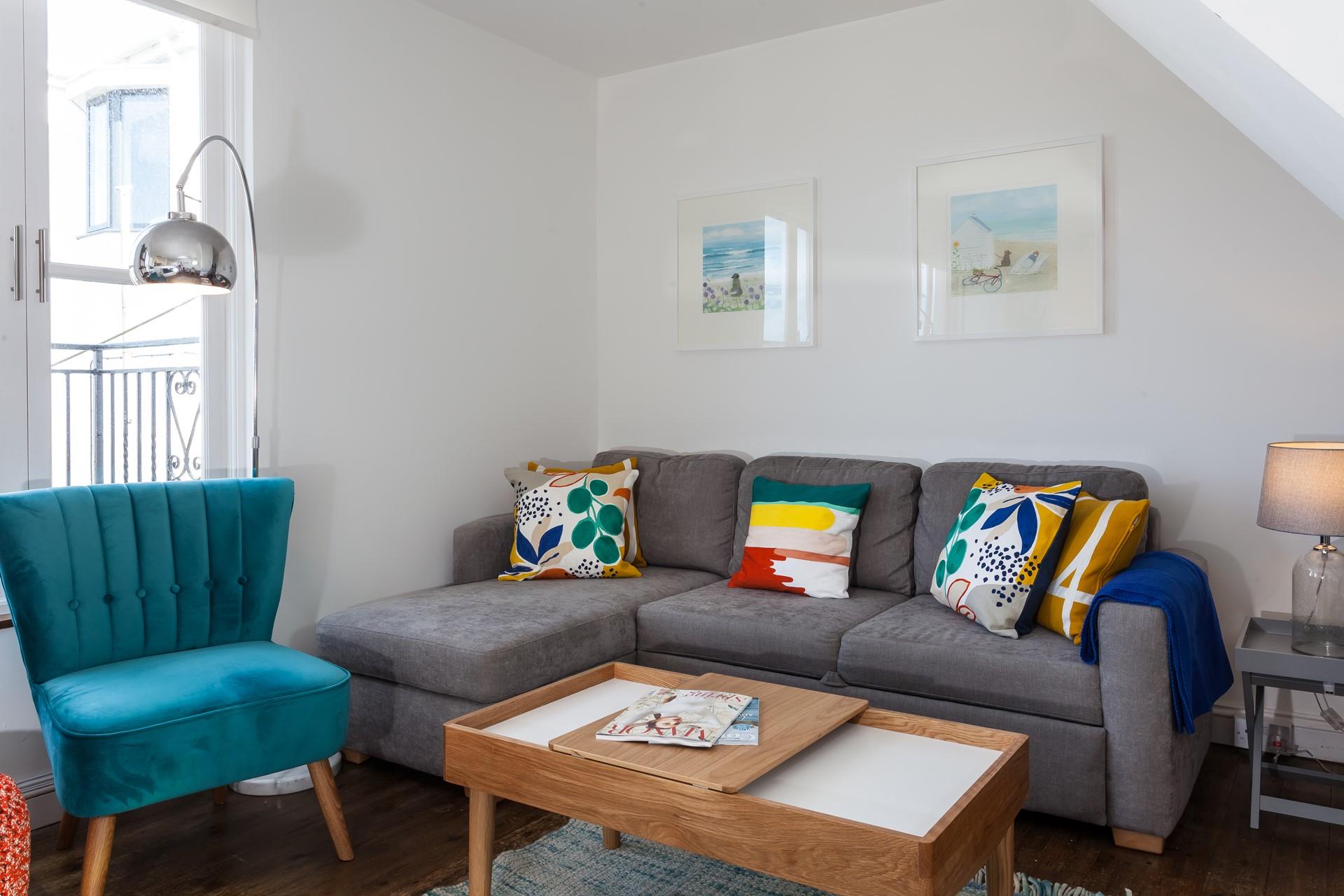 The sitting room has a contemporary style with sea views across the rooftops.