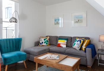 The sitting room has a contemporary style with sea views across the rooftops.