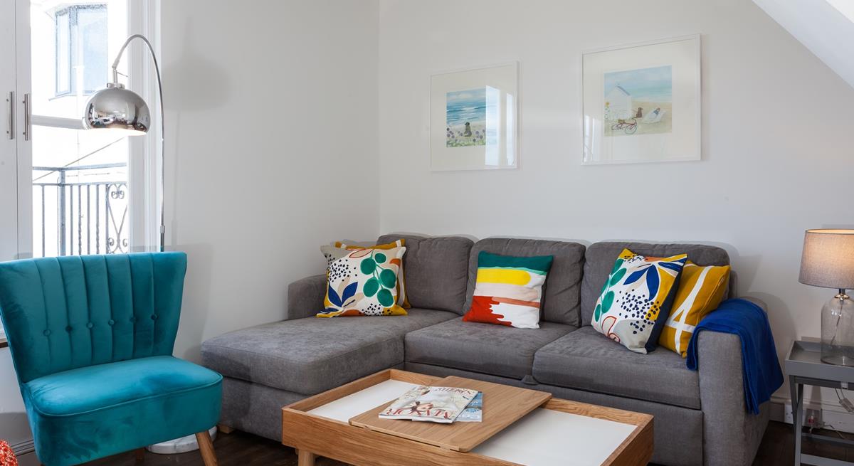 The sitting room has a contemporary style with sea views across the rooftops.