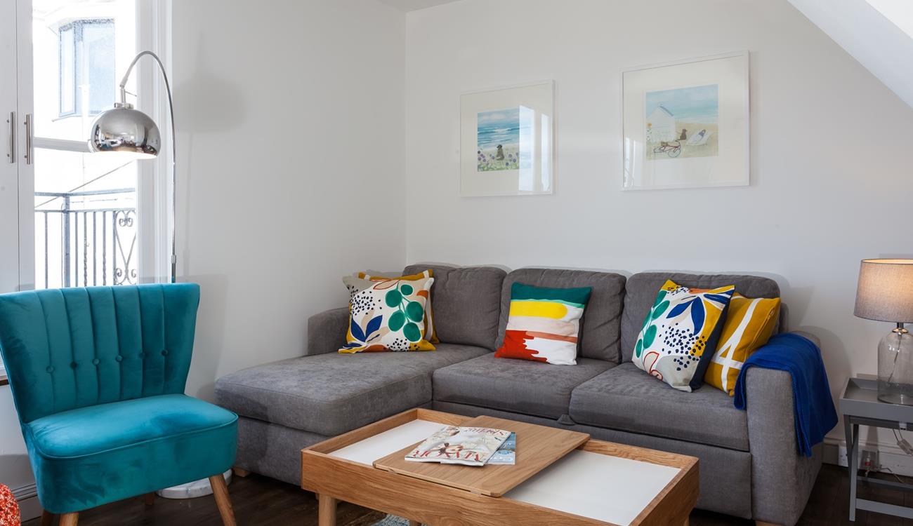 The sitting room has a contemporary style with sea views across the rooftops.
