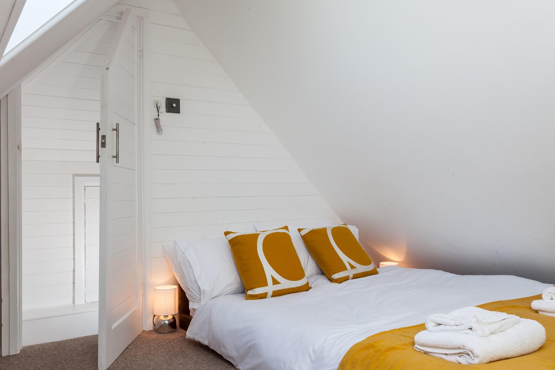 Bedroom 3 is comfortable and decorated with a pop of colour.