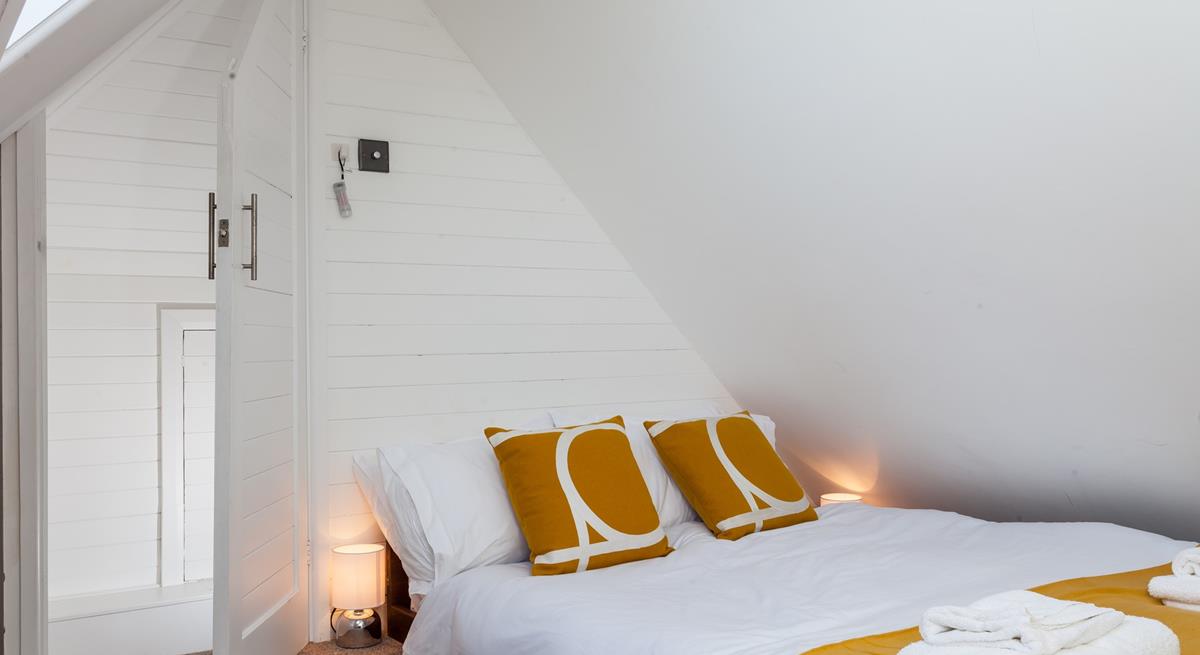 Bedroom 3 is comfortable and decorated with a pop of colour.