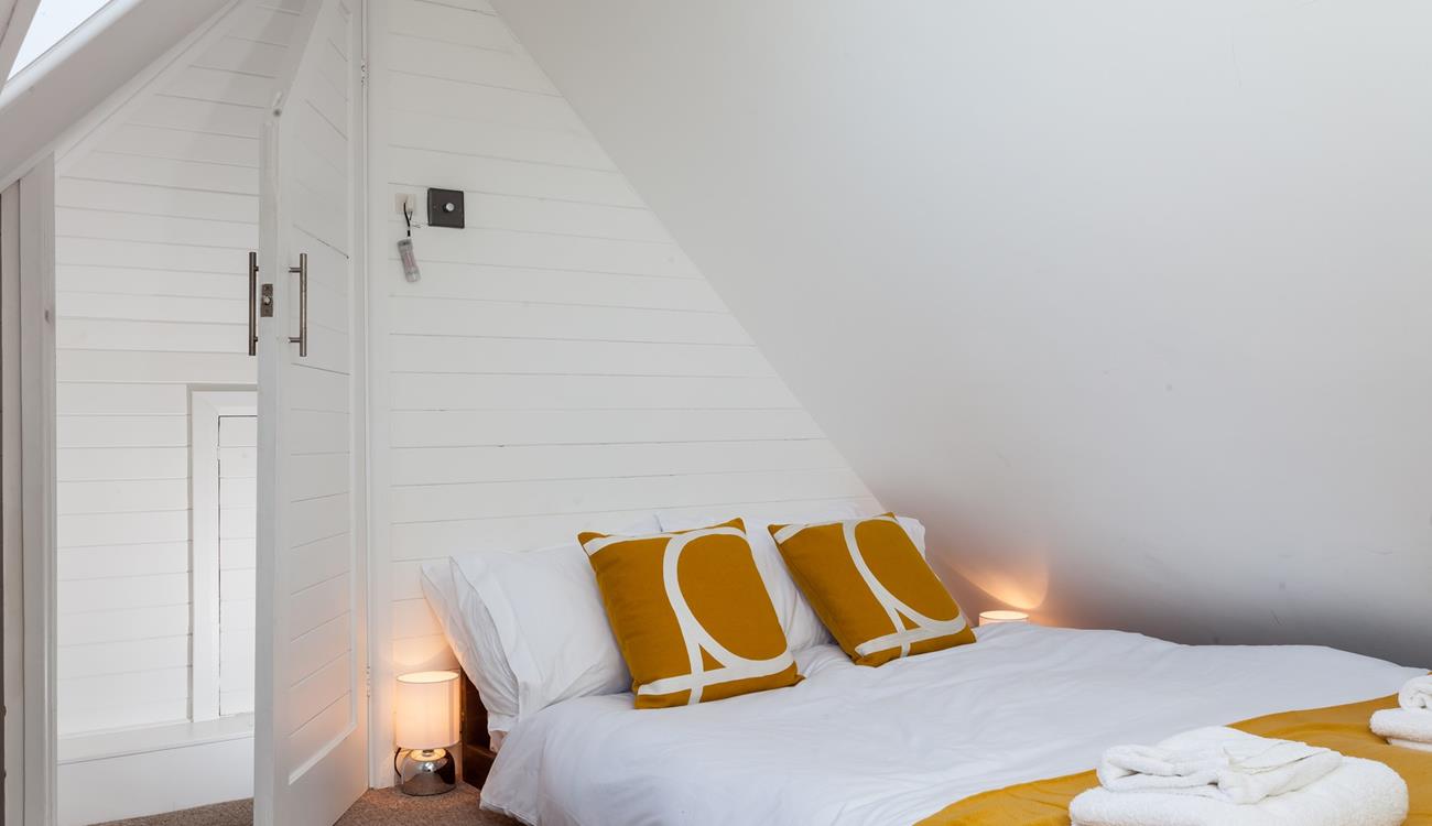 Bedroom 3 is comfortable and decorated with a pop of colour.