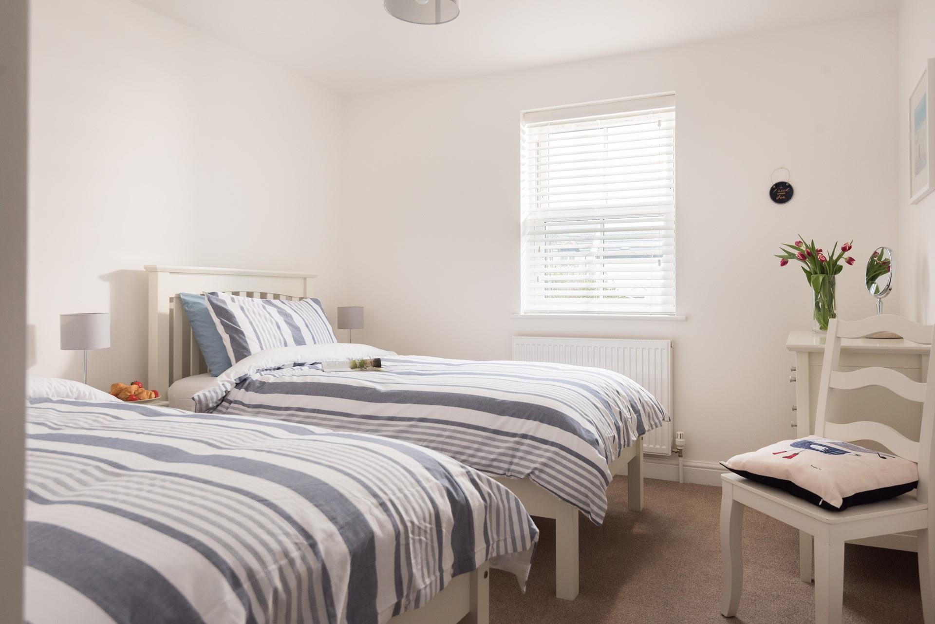 Bedroom 1 offers cosy twin beds, perfect for children or young adults.